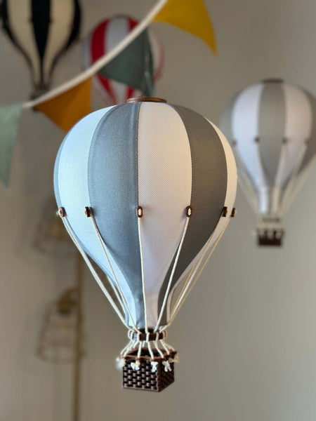 White and dark grey inflatable hot air balloon decoration for baby nursery and room decor, perfect for gender reveal or baby shower themes.