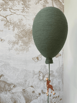 Green hot air balloon decoration with giraffe detail, perfect for baby nursery or gender reveal. Handcrafted and unique home decor piece.