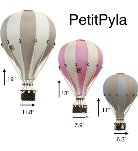 Inflatable hot air balloon decorations in beige, pink, and grey with varying sizes for baby shower or nursery decor.