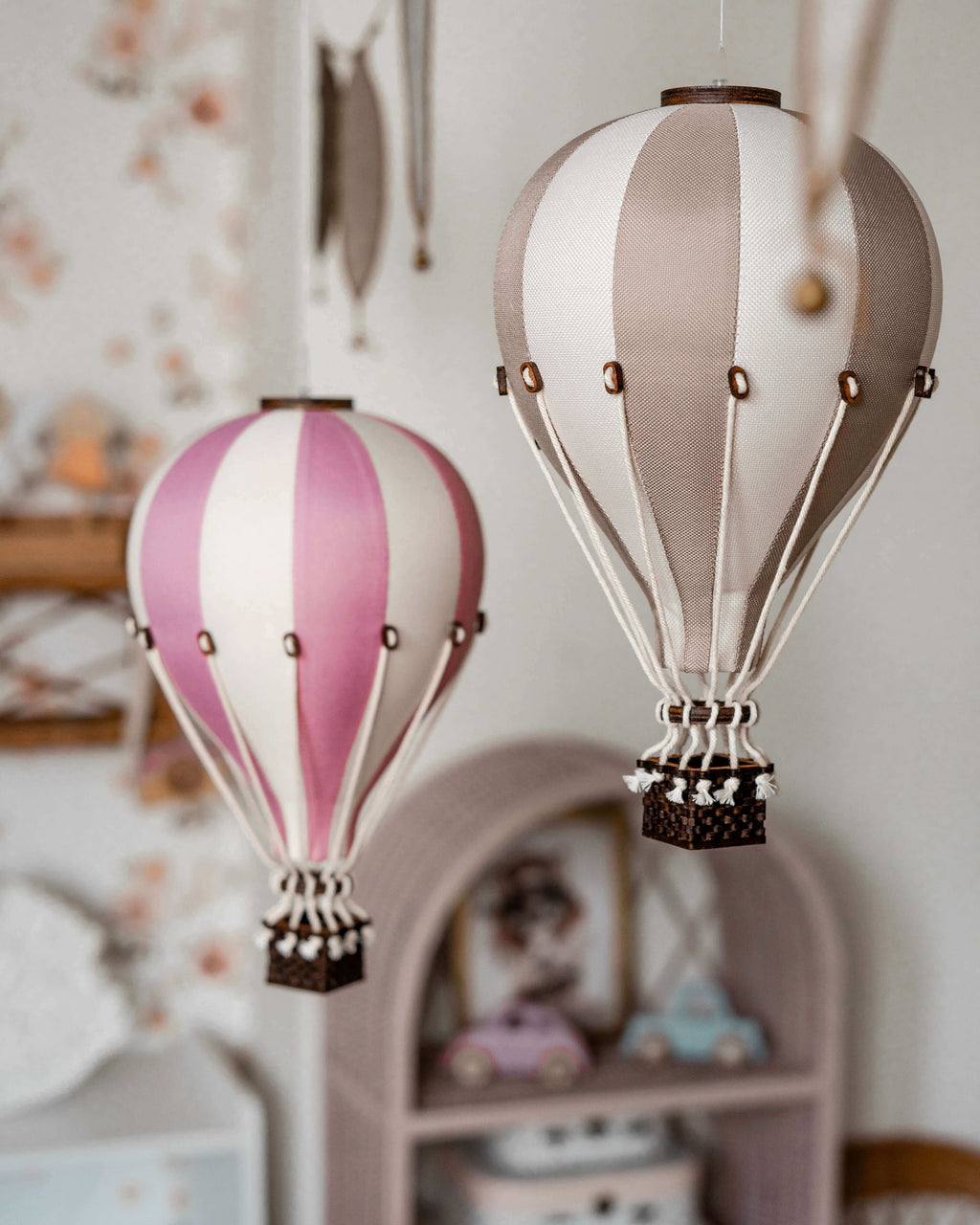 Gold and pink inflatable hot air balloon decorations for baby nursery and gender reveal décor.