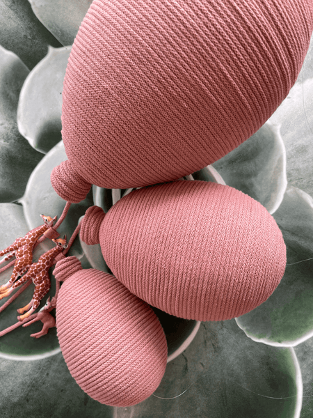 Blush pink handcrafted hot air balloon decorations for baby nursery and gender reveal parties, set of three against a succulent background.