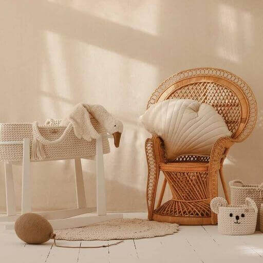 Cozy baby nursery with wicker chair, neutral tones, and plush toys in soft sunlight ambiance.