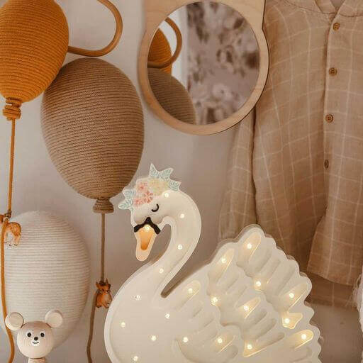 Decorative swan light with hot air balloon and teddy bear accents for nursery decor.